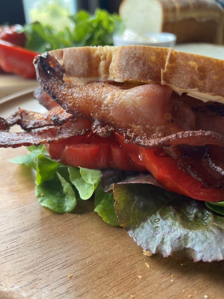 assembled BLT on a wooden plate