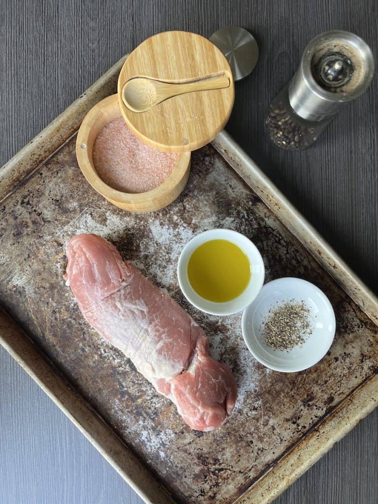 pork tenderloin on baking cheese, oil in a bowl, salt and pepper