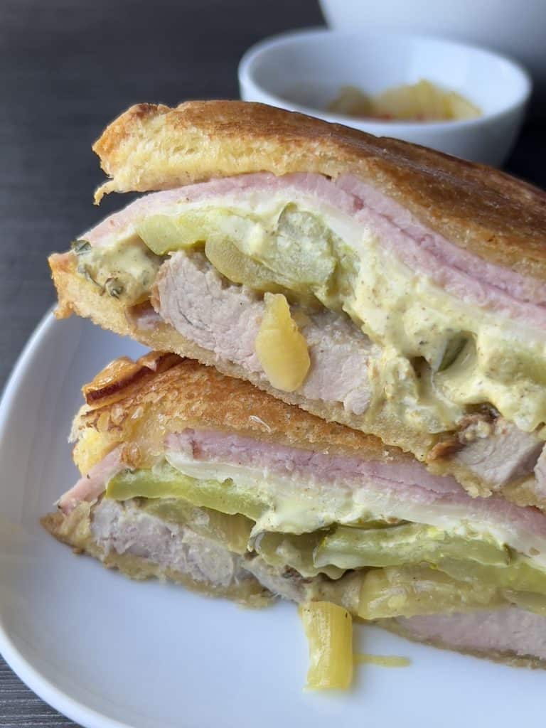 cuban roast pork sandwich assembled on white plate
