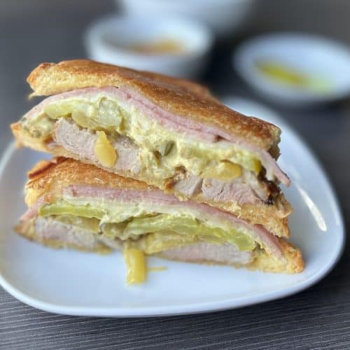 cuban roast pork sandwich assembled on white plate