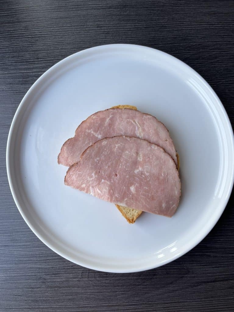 bread and ham on white plate