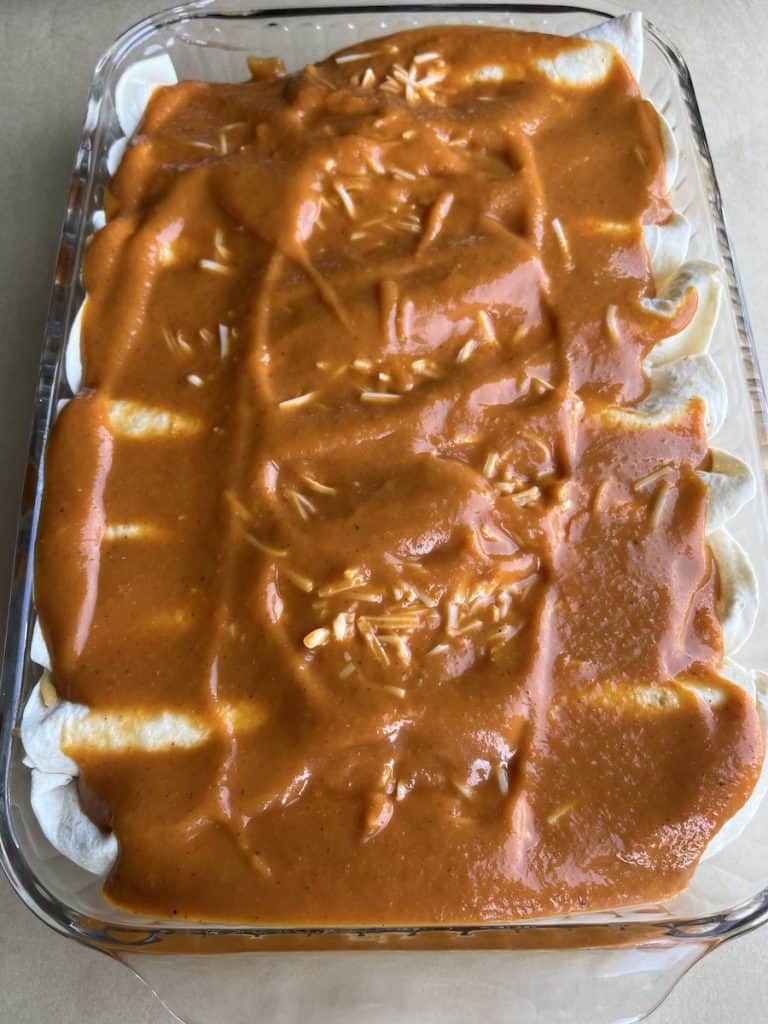 enchiladas with red sauce in a casserole dish