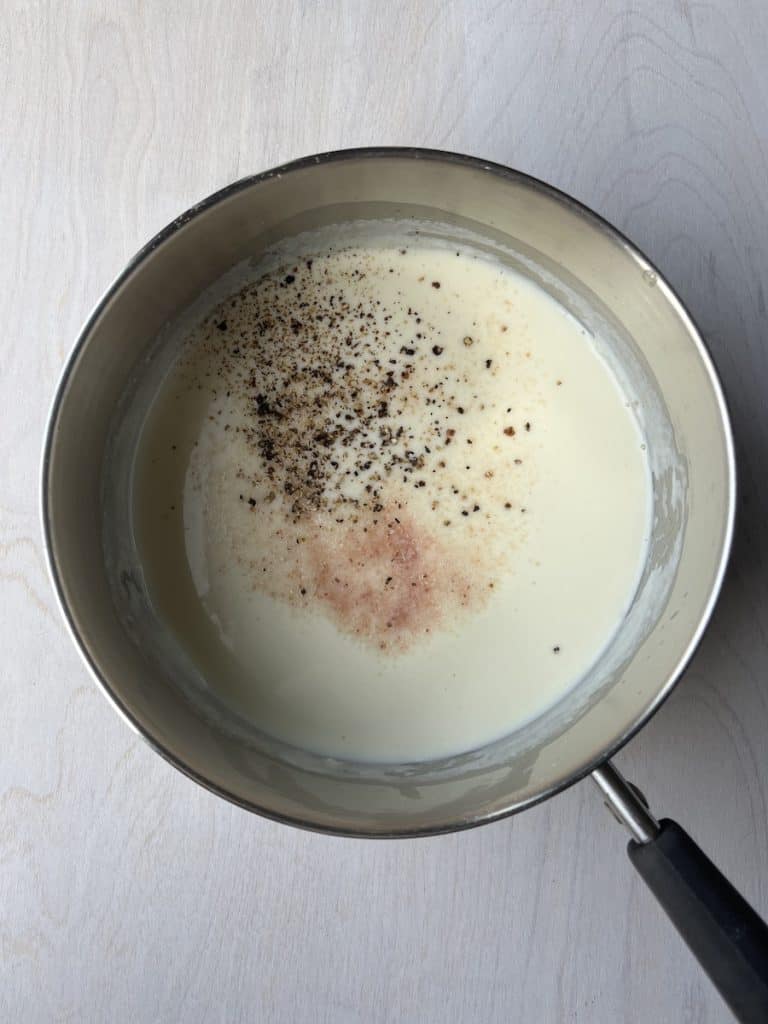 simple creamed cauliflower sauce in a saucepan with salt and pepper step 2