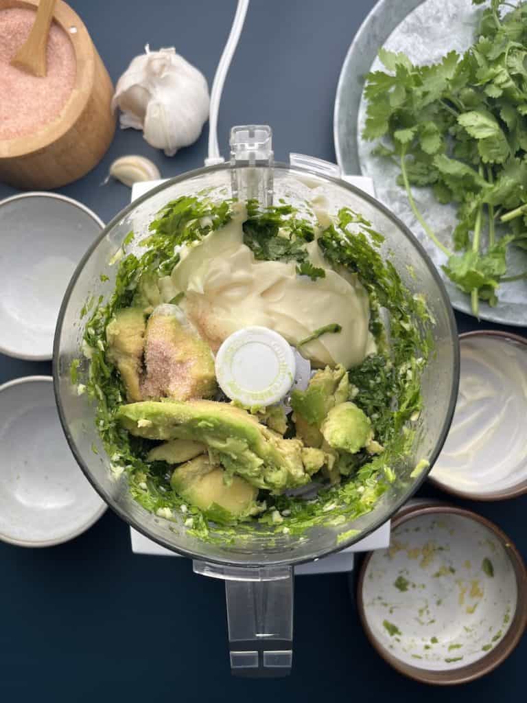 mashed avocado, mayo and salt with cilantro in a food processor to make avocado cilantro aoili