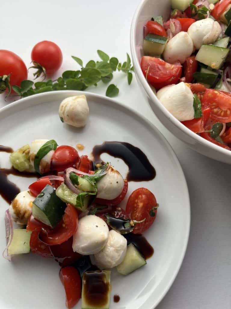 tomato cucumber mozzarella salad on a plate
