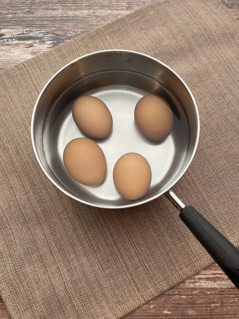 whole eggs in a saucepan with water