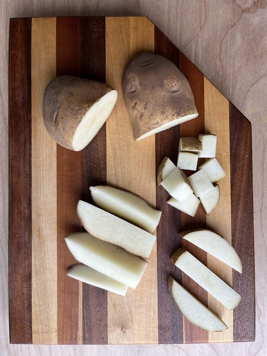 Sliced and diced potatoes on a cutting board