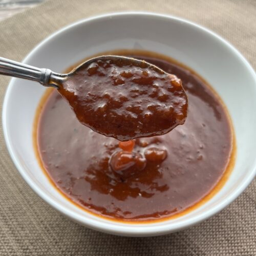 Spinach Salad Dressing in a white bowl with a spoon.