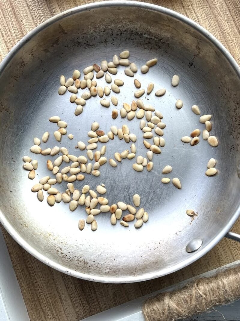 toasted pine nuts in a small pan