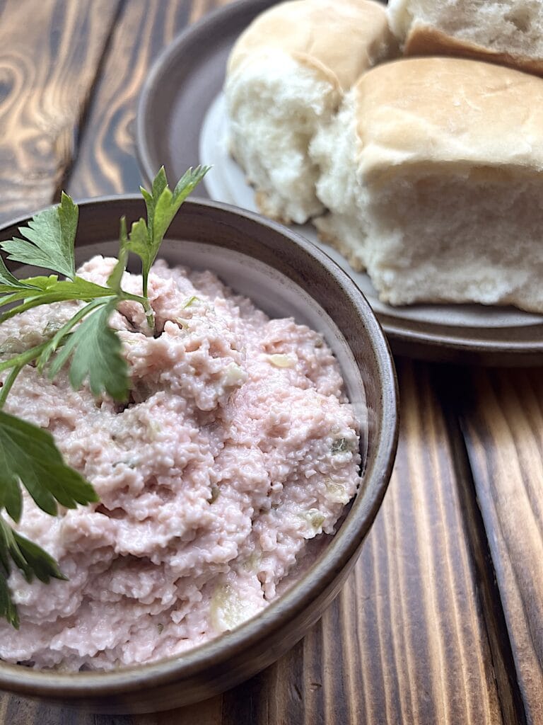 bologna salad in a bowl with bread in the background