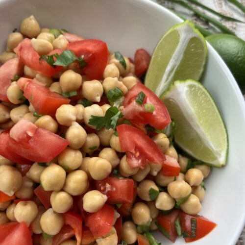 mixed easy chickpea salsa in a bowl with limes