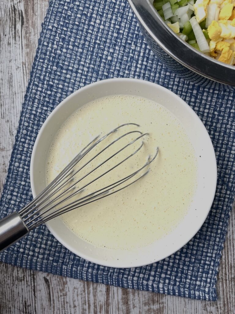 dressing with a whisk in a bowl