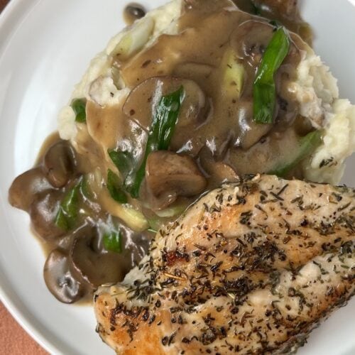 chicken marsala with mashed potatoes on a plate