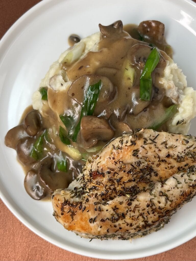 chicken marsala with mashed potatoes on a plate