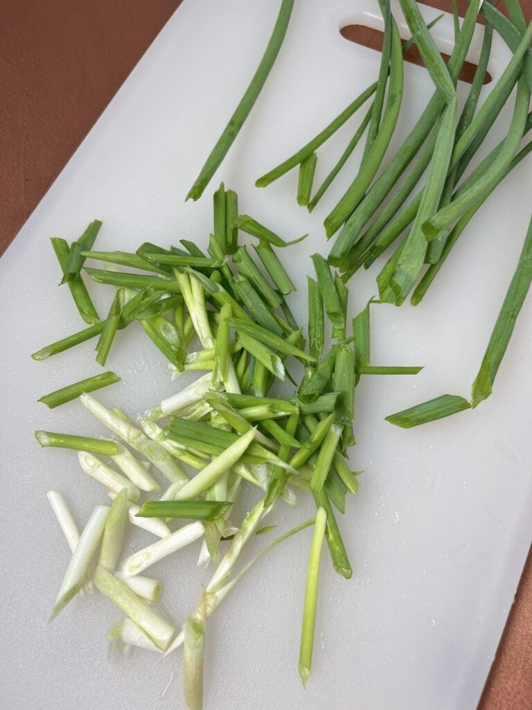 sliced green onions on a cutting board